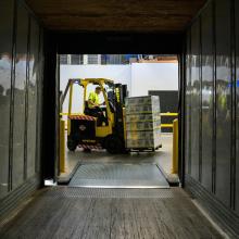 forklift in view from inside freight truck